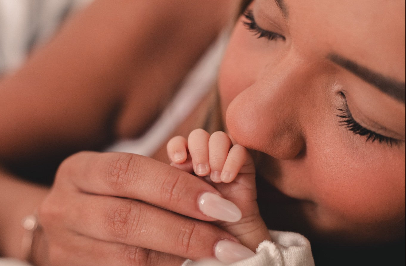 Mother holding infant — eczema in infants affects up to 1 in 5 babies in the first year of life