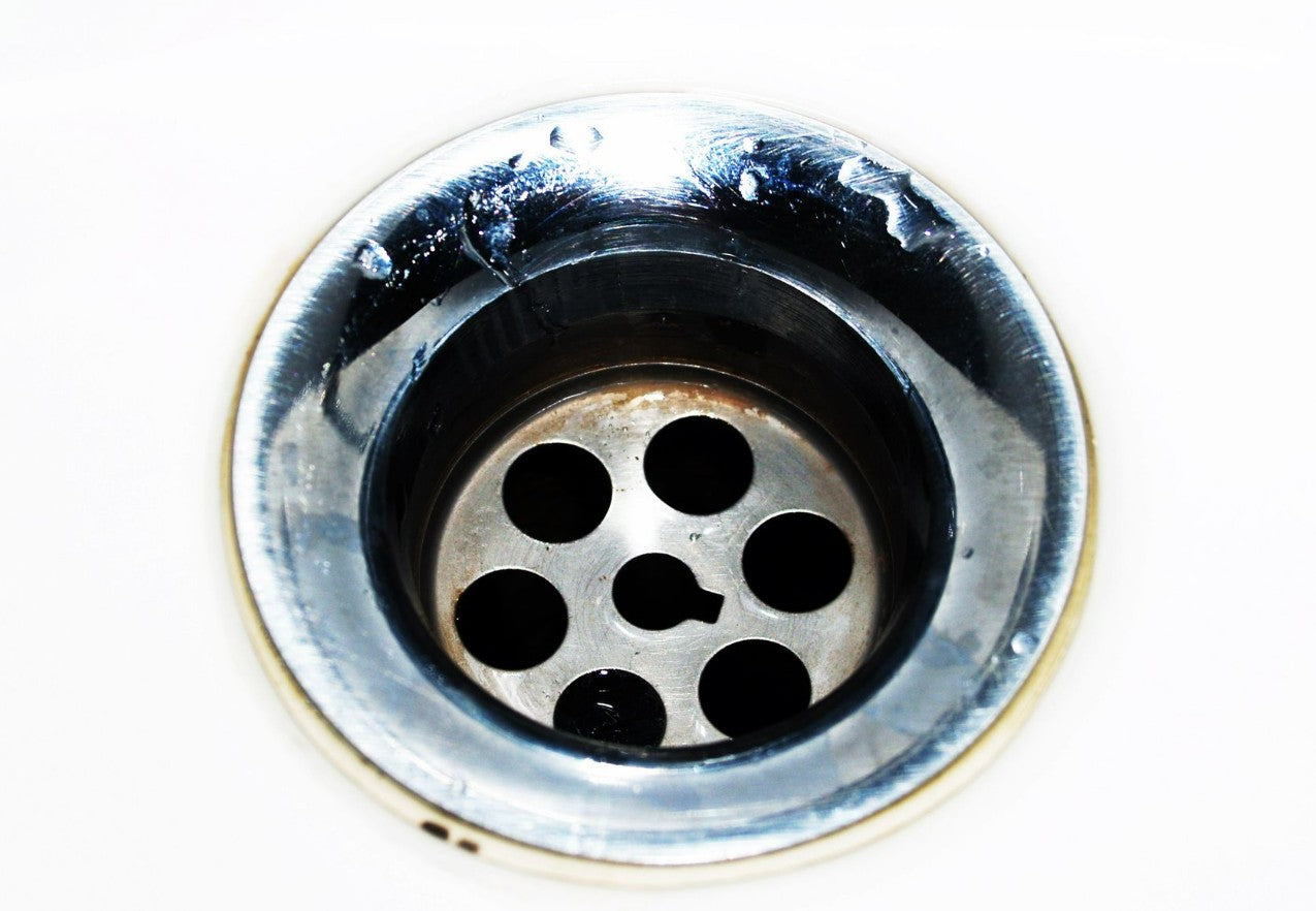 Stainless steel kitchen sink drain viewed from above
