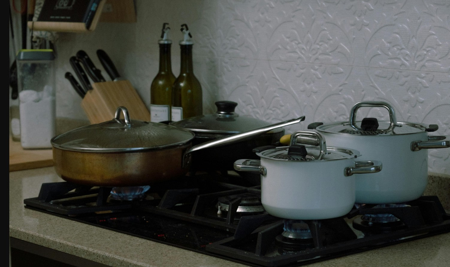 Non-toxic pots and pans on a gas stove — stainless steel and cast iron cookware for safe, healthy cooking