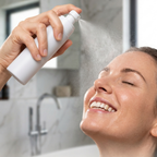 woman holding a mist spray bottle to spray her face